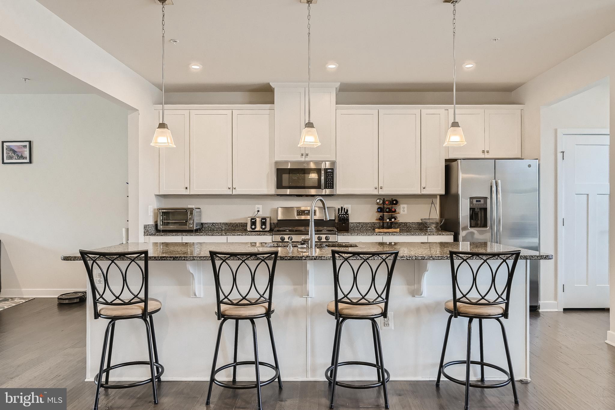 737 Iron Gate Road Bel Air, MD 21014 - Photo 11 of 27 a kitchen with stainless steel appliances a table chairs refrigerator and microwave