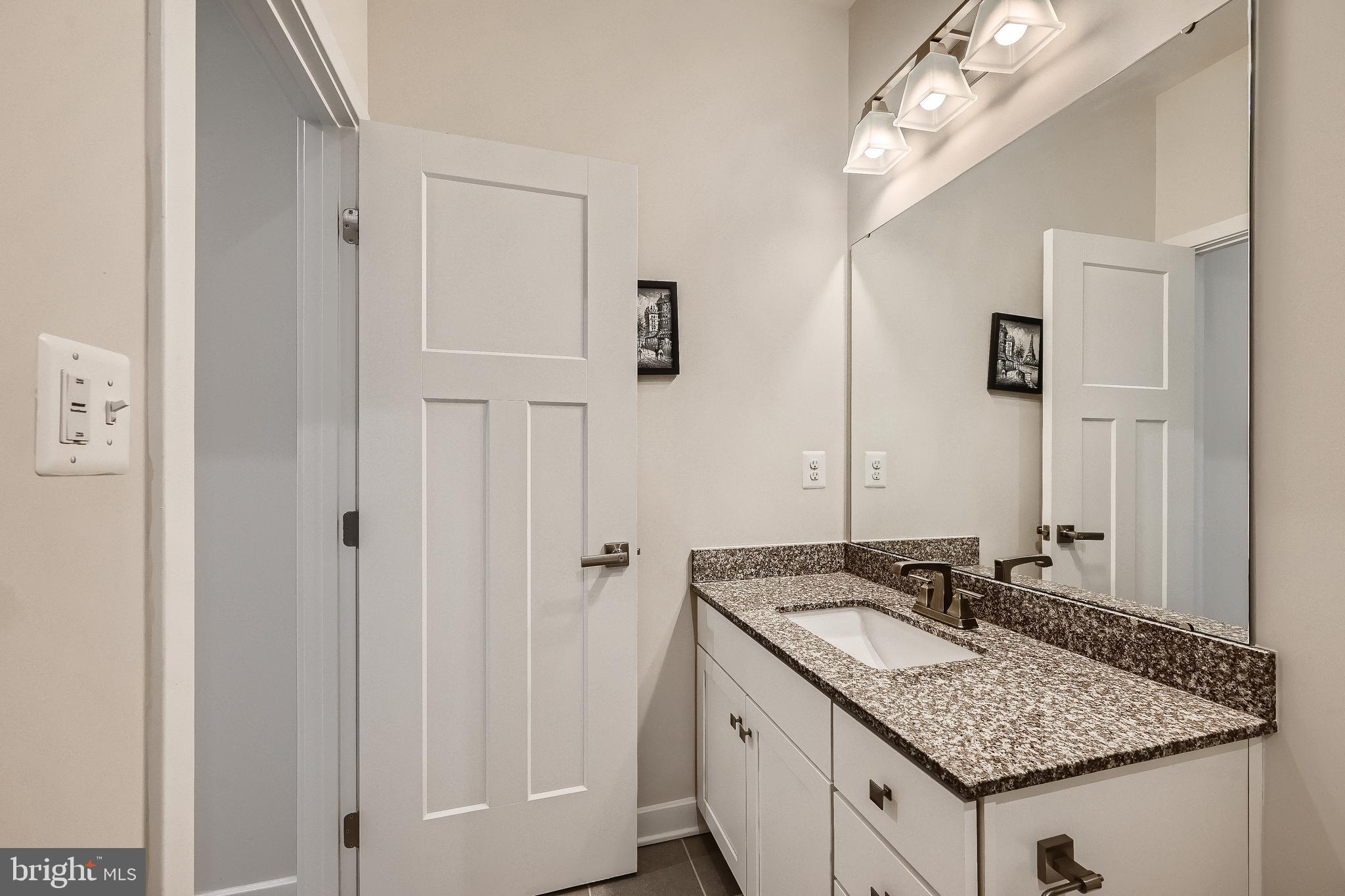 737 Iron Gate Road Bel Air, MD 21014 - Photo 20 of 27 a bathroom with a granite countertop sink and a mirror