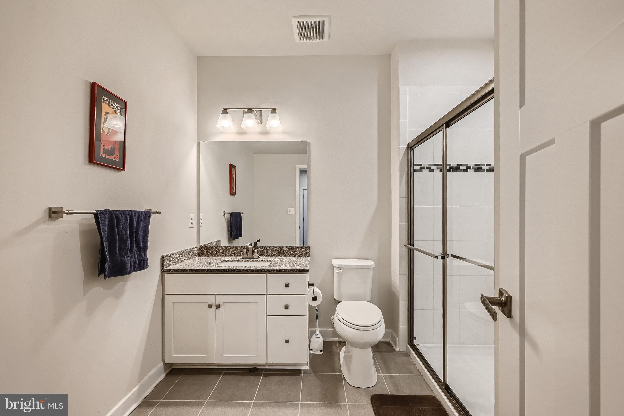 737 Iron Gate Road Bel Air, MD 21014 - Photo 23 of 27 a bathroom with a granite countertop sink toilet and shower