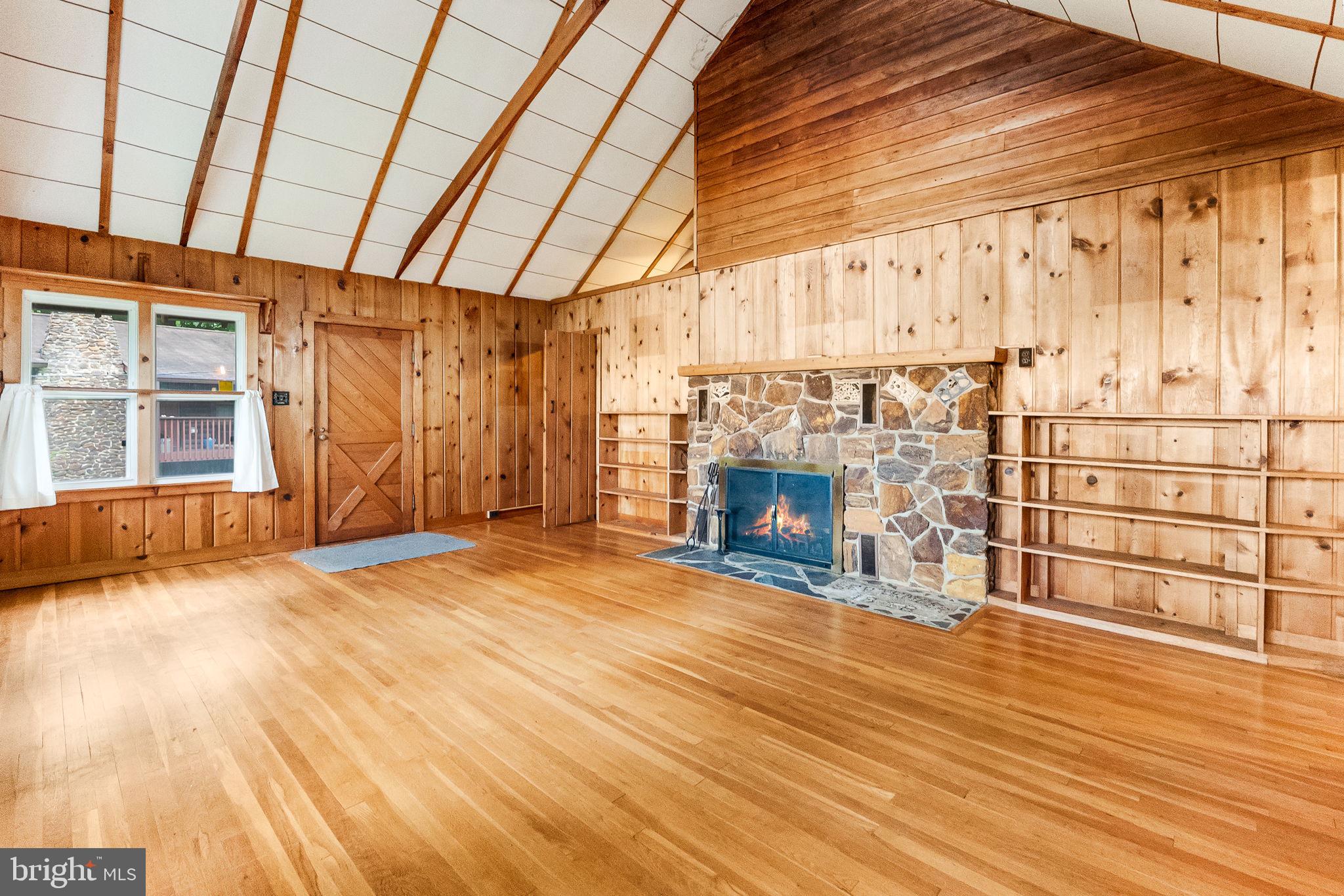 2138 Cedar Road Port Republic, MD 20676 - Photo 12 of 34 a view of empty room with wooden floor and fireplace