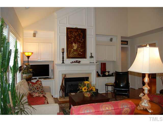 3733 Old Post Road Raleigh, NC 27612 - Photo 10 of 25 FRoom w/hardwoods, vaulted ceiling, surround sound, open, 4 double windows, w/ 2?faux wood Plantation blinds, FP w/gas logs, white marble hearth & surround, custom & white wood mantle w/white wood wainscoting to the vaulted ceiling top! Den/Family/Great Room