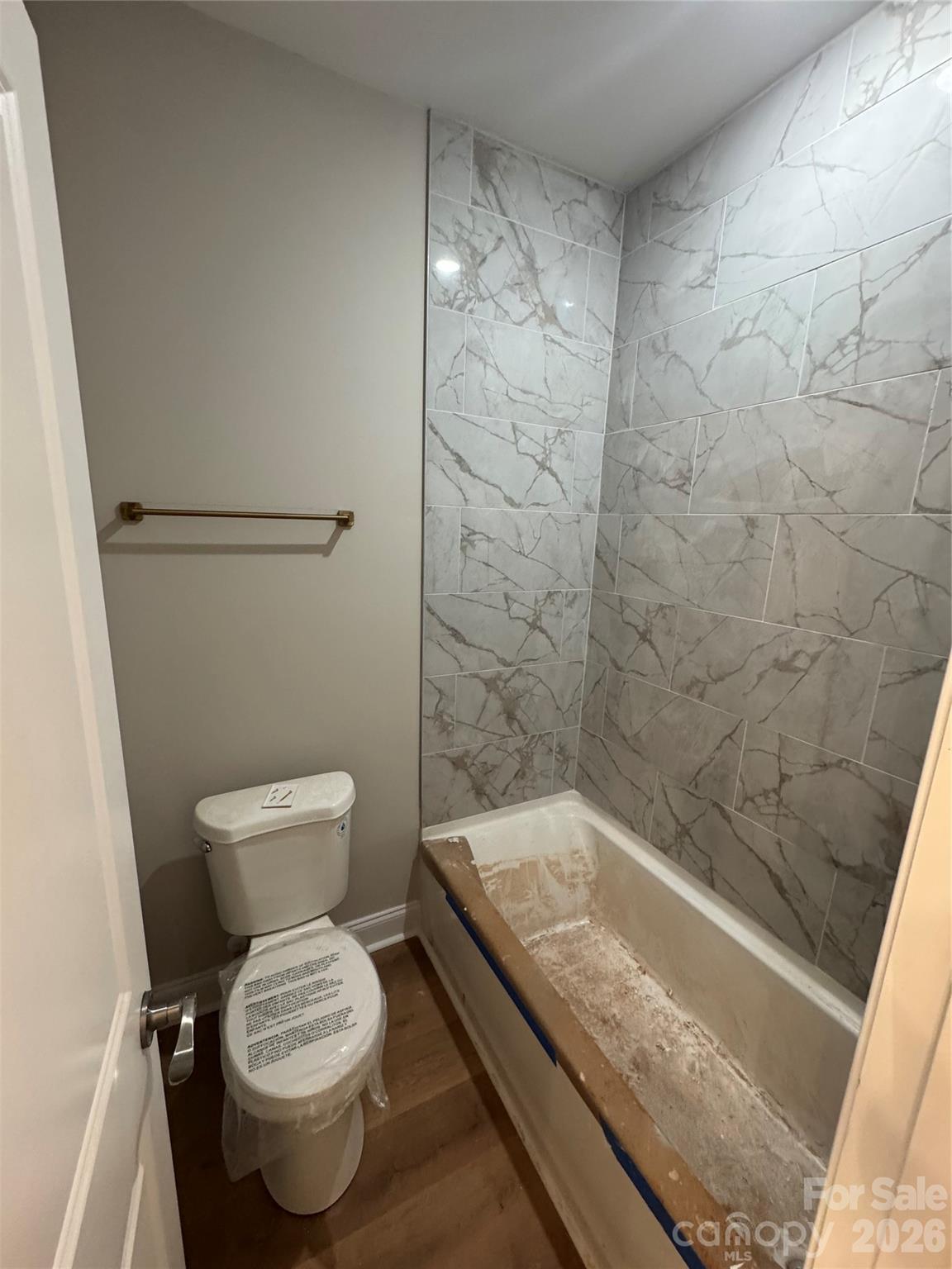 203 Lee Street Fort Mill, SC 29715 - Photo 14 of 16 a bathroom with a granite countertop bathtub and toilet