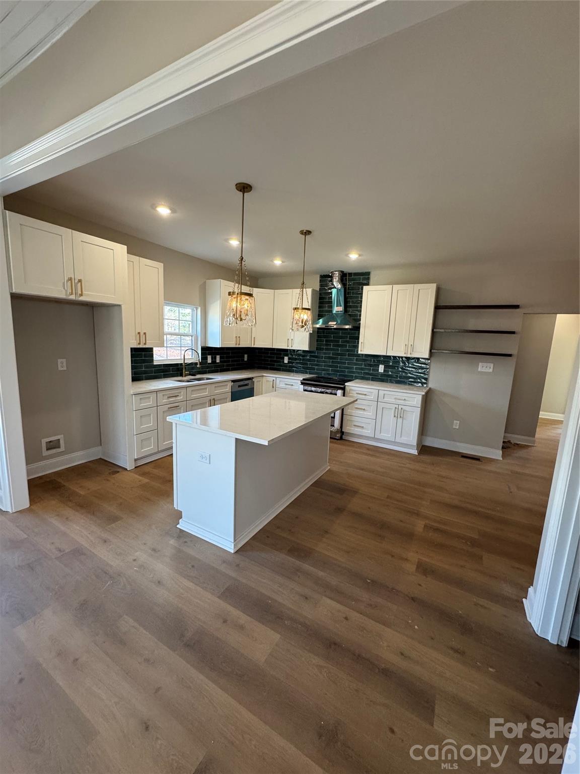 203 Lee Street Fort Mill, SC 29715 - Photo 6 of 16 a large kitchen with stainless steel appliances kitchen island granite countertop a stove a sink and a granite counter top