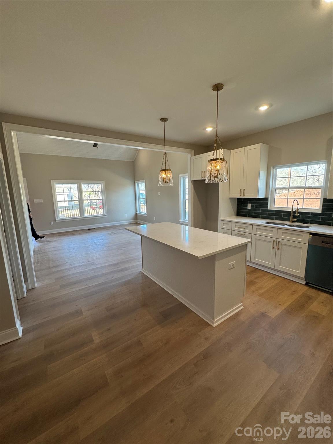 203 Lee Street Fort Mill, SC 29715 - Photo 7 of 16 a large kitchen with granite countertop a large counter top stainless steel appliances and cabinets
