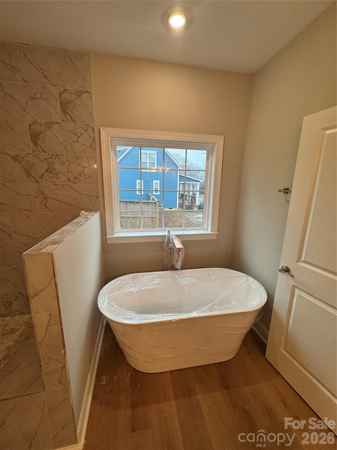 203 Lee Street Fort Mill, SC 29715 - Photo 9 of 16 a bed sitting in a bathroom next to a window