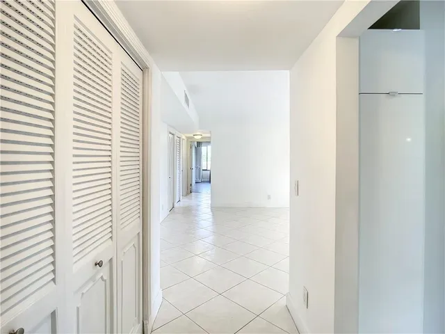 a view of a room with a window and a ceiling fan
