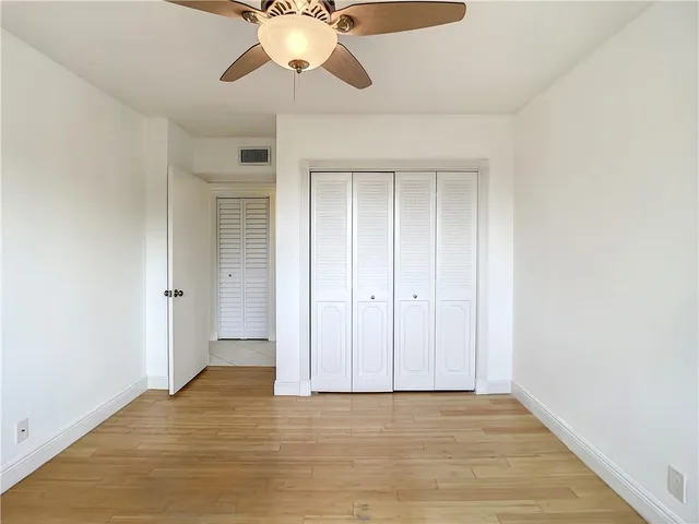 a view of an empty room and wooden floor