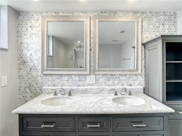 a bathroom with a sink and a mirror