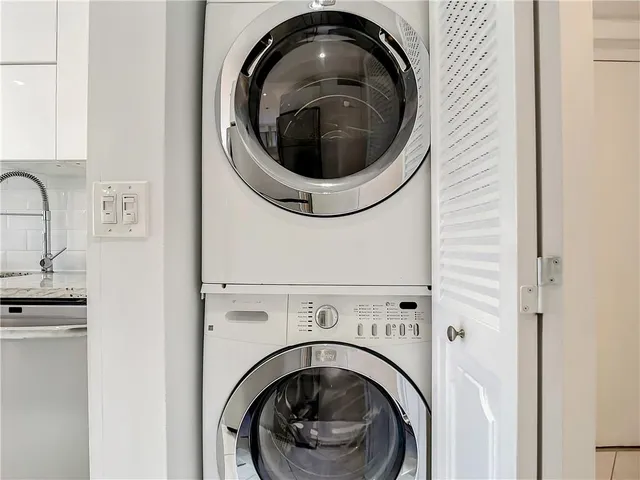 a close view of a utility room with dryer and washer