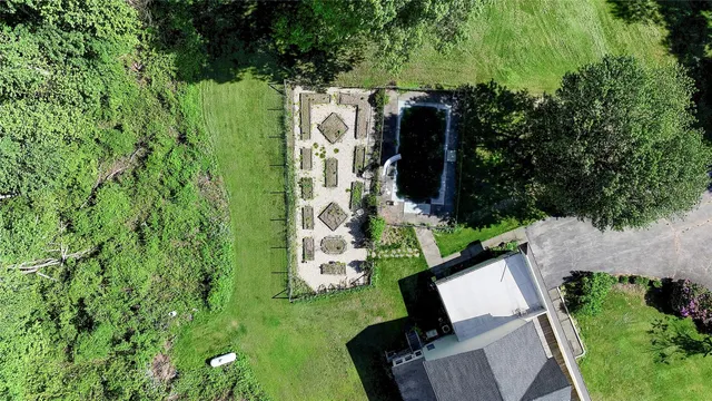 an aerial view of a house with a yard basket ball court and outdoor seating