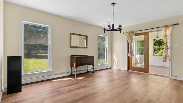 a view of a livingroom with furniture window and wooden floor