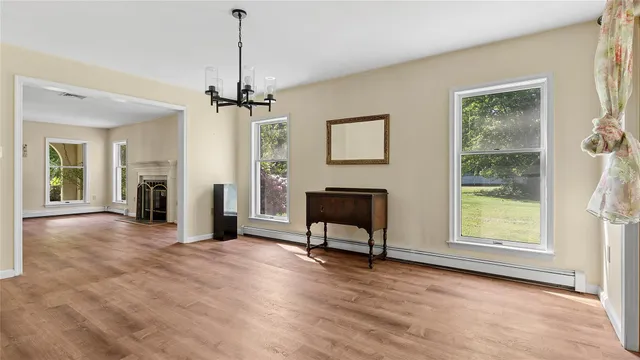 a view of a livingroom with furniture a ceiling fan and window