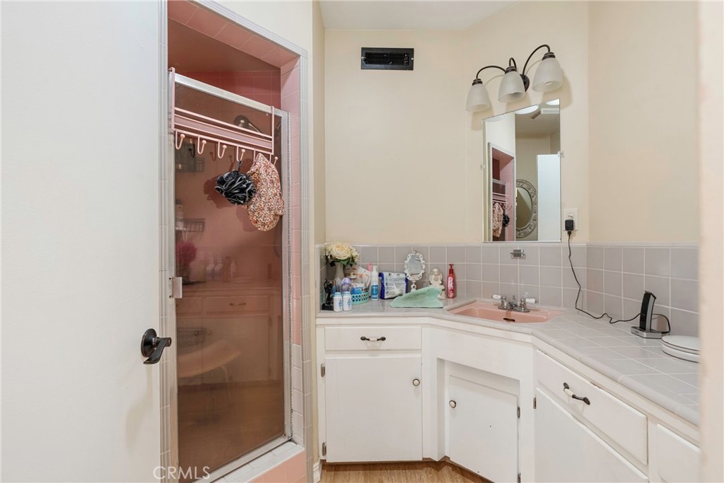 1000 1st Street Wasco, CA 93280 - Photo 16 of 75 a bathroom with a sink and a mirror