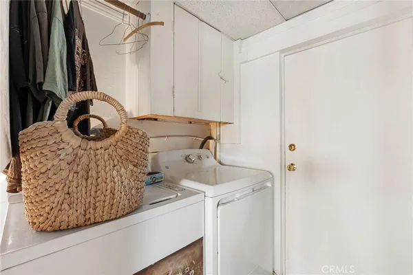 a kitchen with a sink cabinets and wooden floor