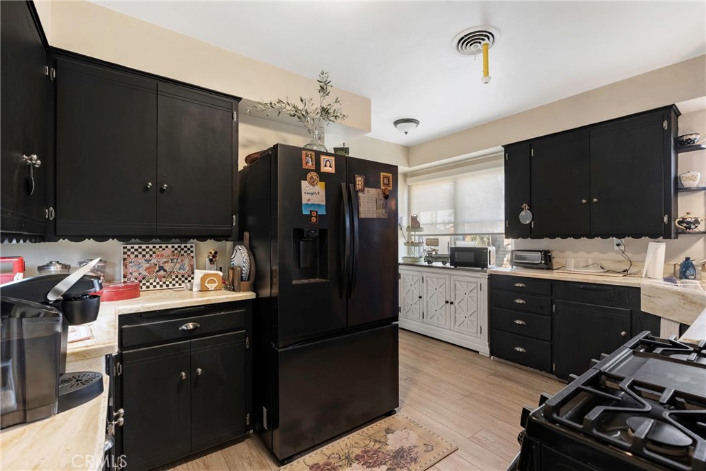 1000 1st Street Wasco, CA 93280 - Photo 25 of 75 a kitchen with a refrigerator and a stove top oven