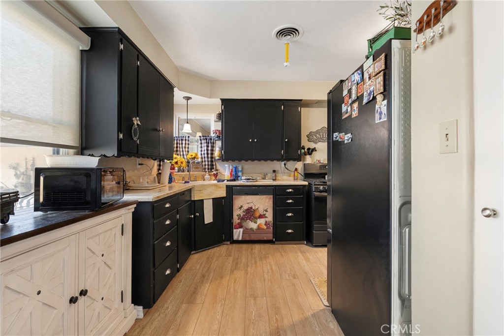 1000 1st Street Wasco, CA 93280 - Photo 28 of 75 a kitchen with stainless steel appliances granite countertop a refrigerator a stove top oven a sink and dishwasher