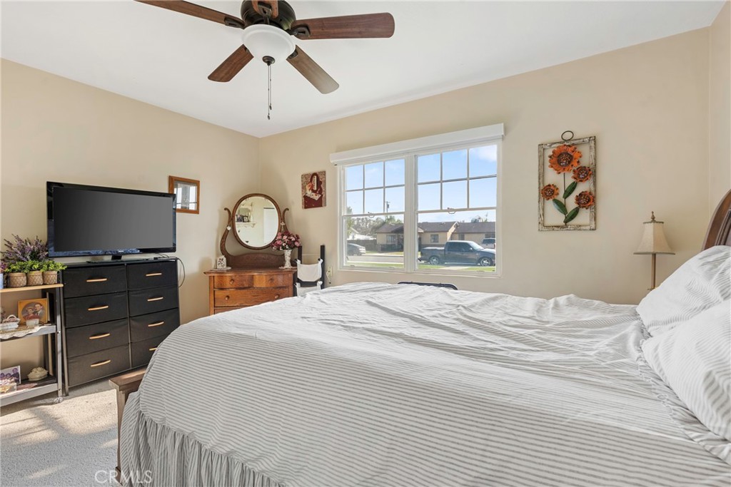 1000 1st Street Wasco, CA 93280 - Photo 34 of 75 a bedroom with a bed and a flat tv screen on dresser