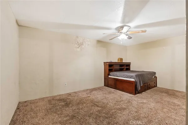 a living room with lots of furniture and kitchen view