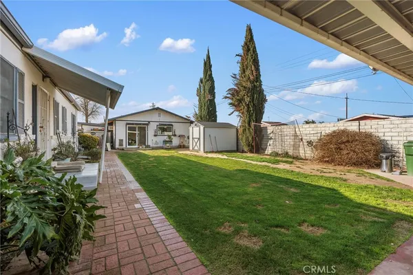 an aerial view of a house with a garden and parking space