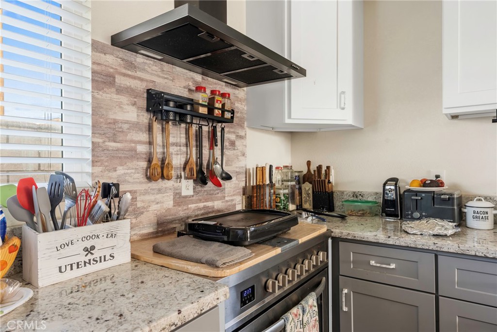 1000 1st Street Wasco, CA 93280 - Photo 63 of 75 a kitchen with granite countertop a stove and a sink