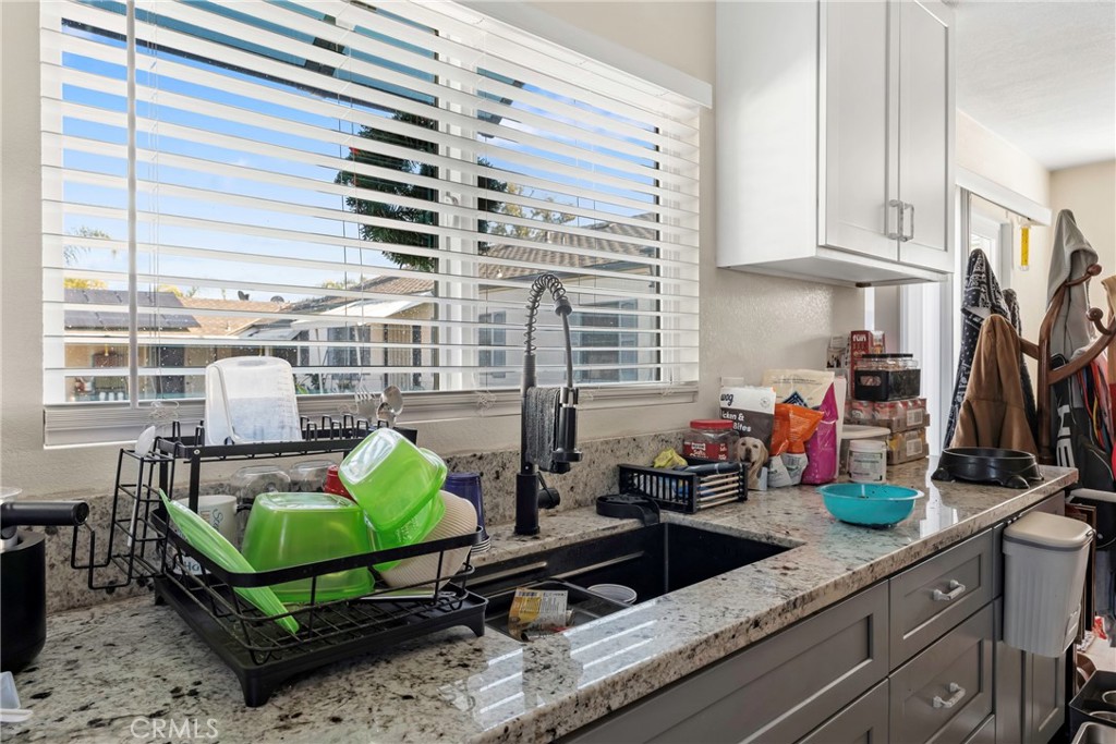 1000 1st Street Wasco, CA 93280 - Photo 64 of 75 a kitchen with stainless steel appliances kitchen island granite countertop a sink a counter top space and a window