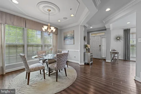 a dining room with furniture window and wooden floor