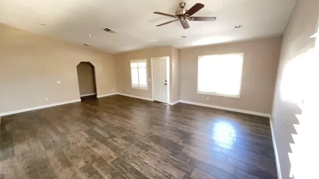 a view of a room with wooden floor and window