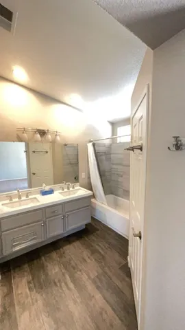 a bathroom with a tub and shower