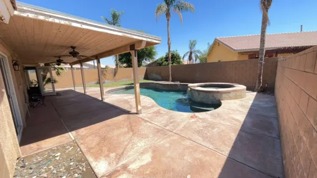a backyard of a house with table and chairs