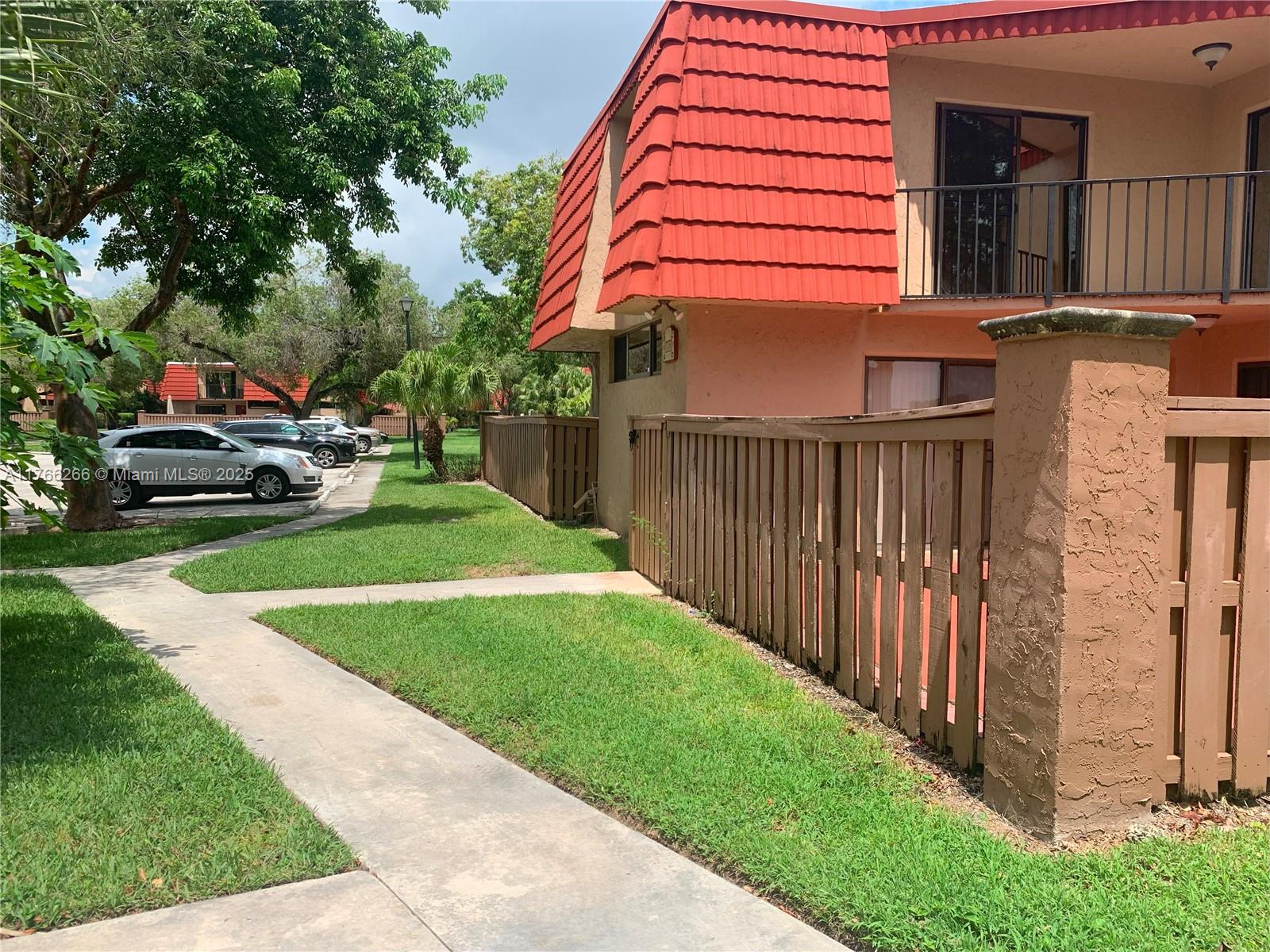8063 Severn Drive, Unit D Boca Raton, FL 33433 - Photo 3 of 20 a yellow house with outdoor space