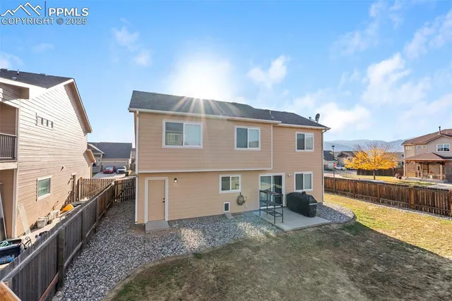 a view of a house with a backyard