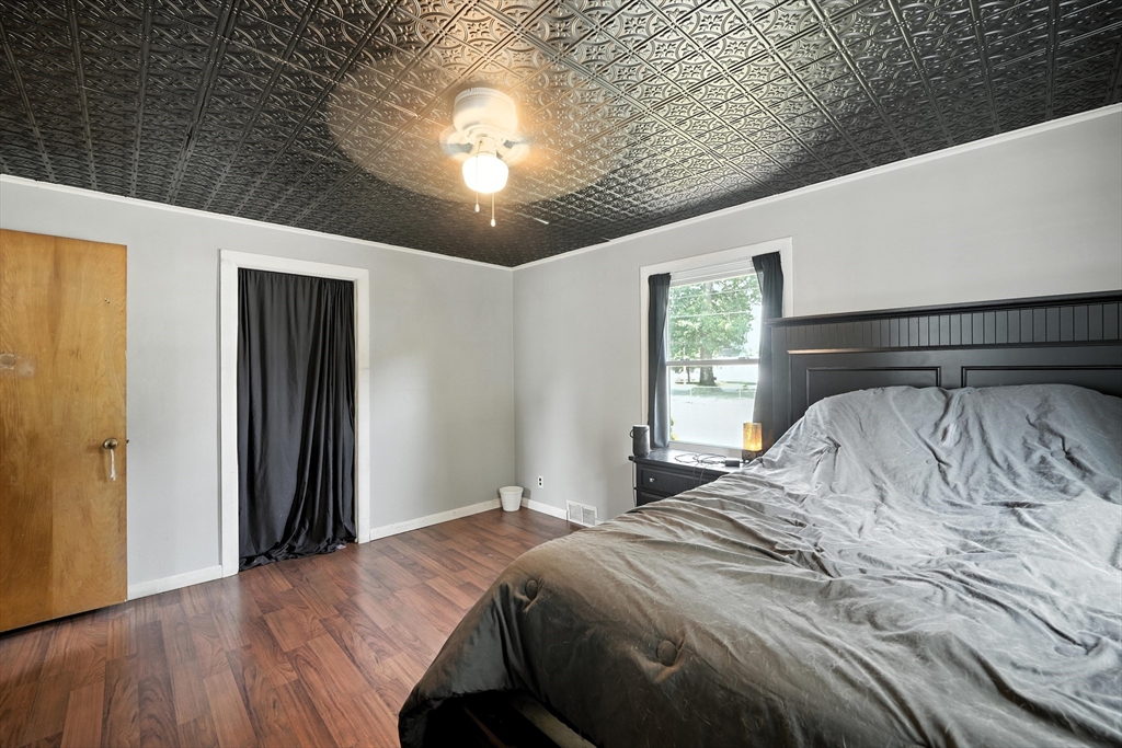 721 Pendleton Avenue Chicopee, MA 01020 - Photo 33 of 36 a bedroom with a large bed and a chandelier