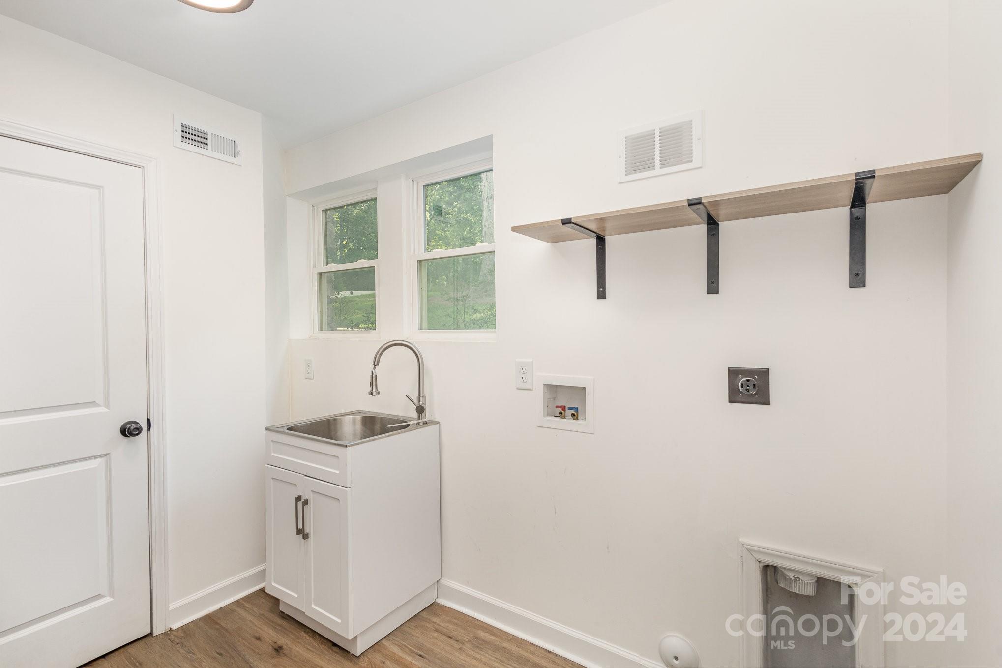10625 East Lake Road Charlotte, NC 28215 - Photo 15 of 44 a bathroom with a sink and a mirror