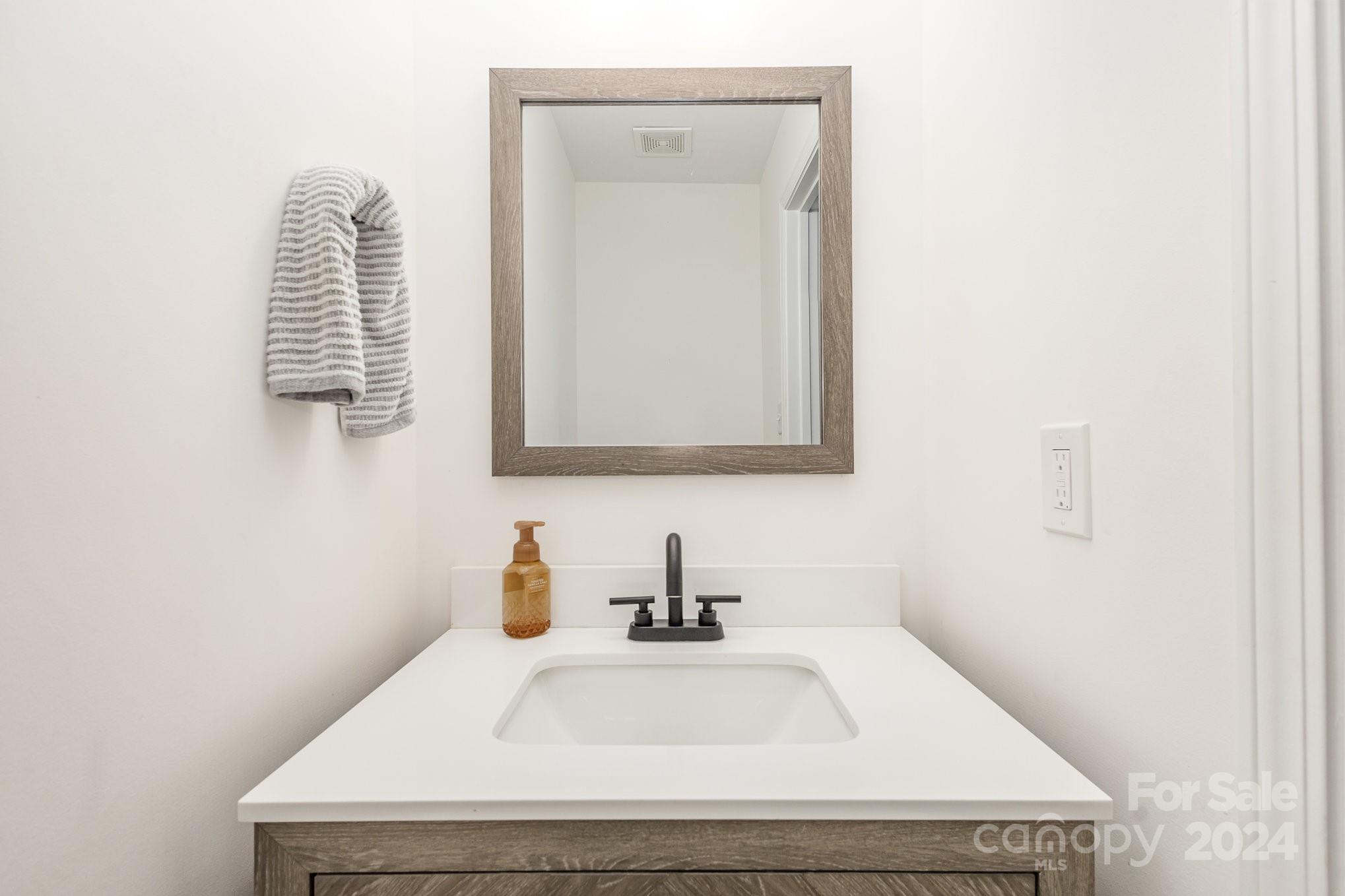 10625 East Lake Road Charlotte, NC 28215 - Photo 17 of 44 a bathroom with a sink and a mirror