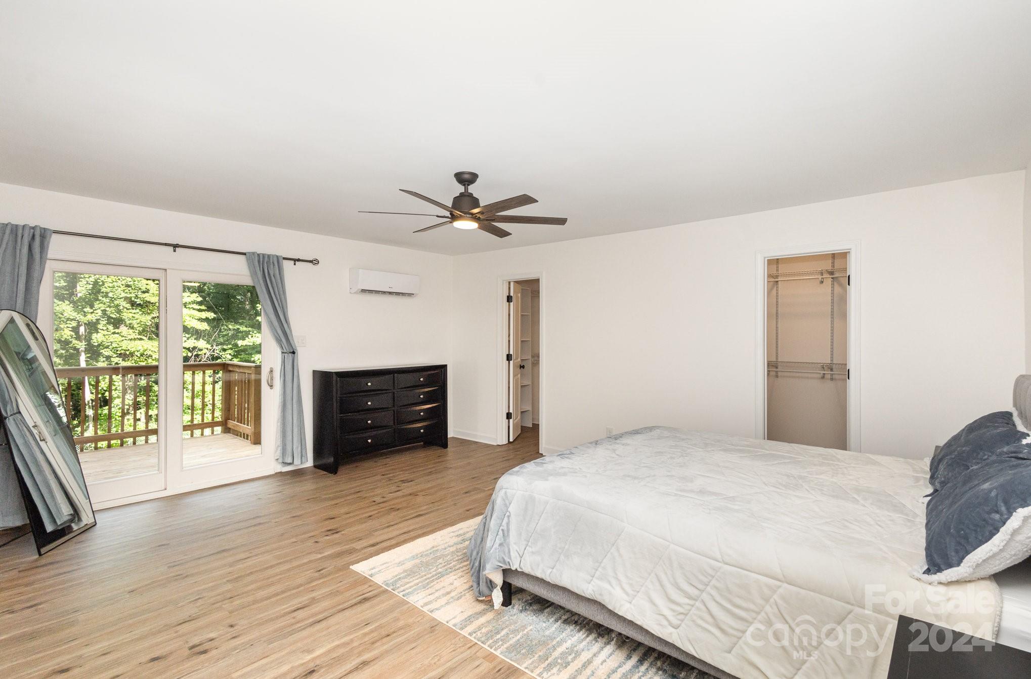 10625 East Lake Road Charlotte, NC 28215 - Photo 20 of 44 a spacious bedroom with a bed and a large window
