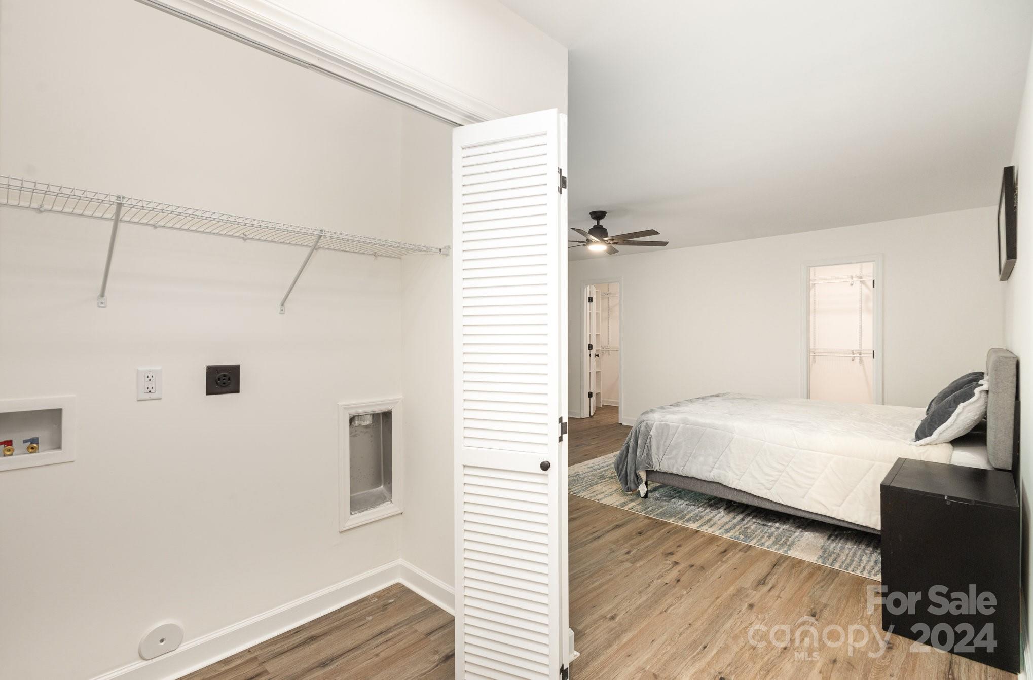 10625 East Lake Road Charlotte, NC 28215 - Photo 22 of 44 a bedroom with a bed and wooden floor