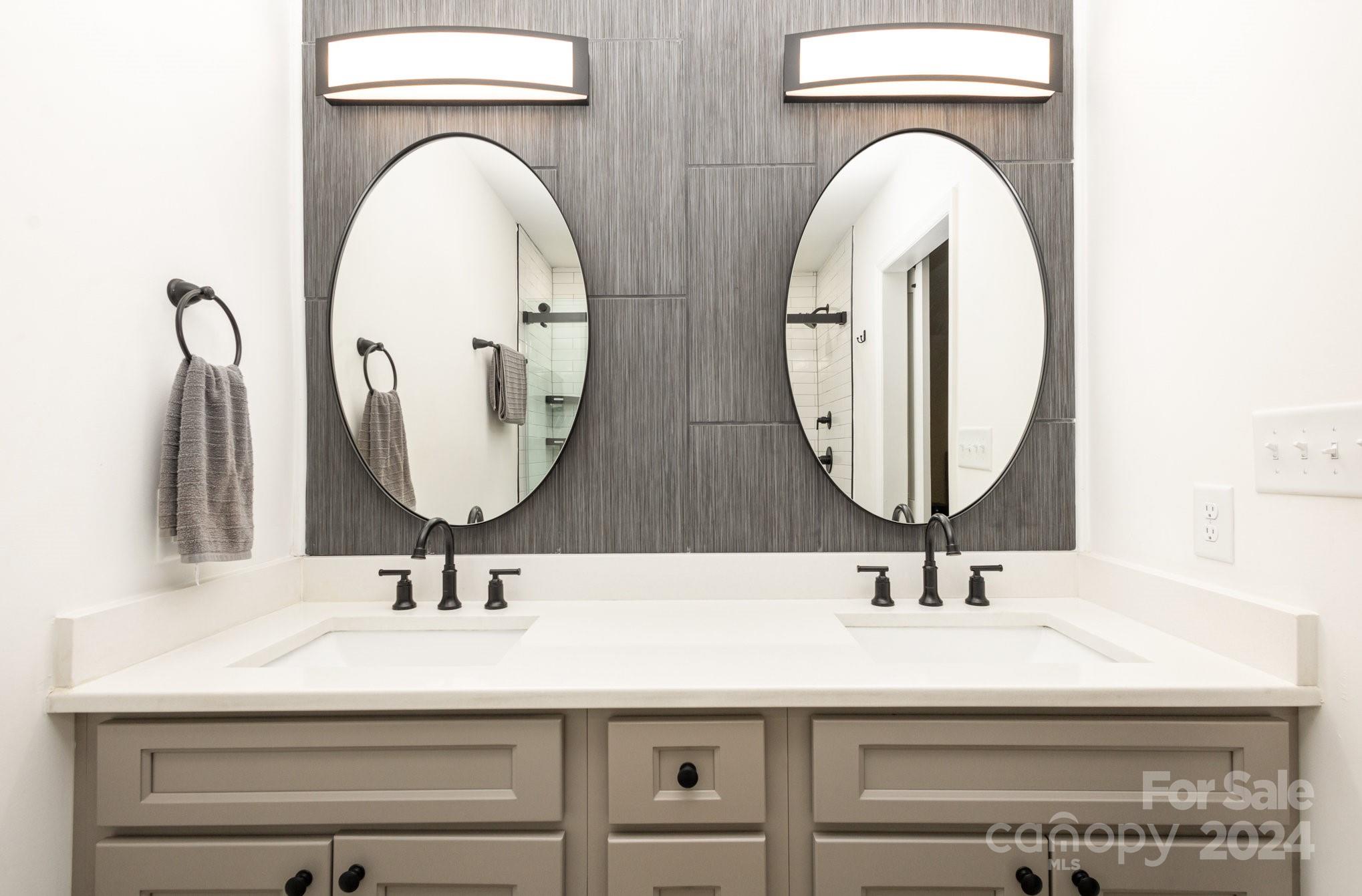10625 East Lake Road Charlotte, NC 28215 - Photo 23 of 44 a bathroom with a sink and a mirror