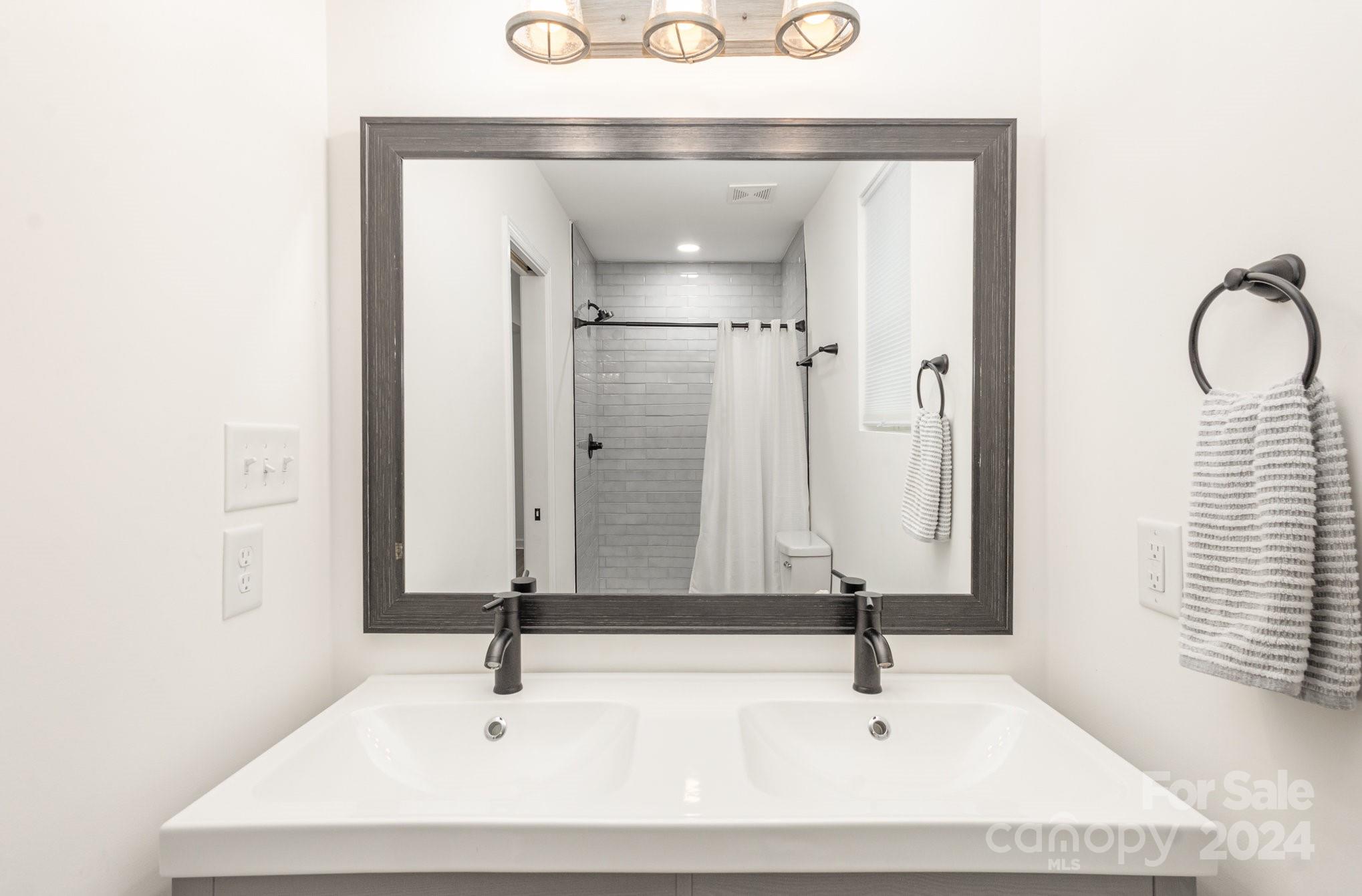 10625 East Lake Road Charlotte, NC 28215 - Photo 28 of 44 a bathroom with a sink