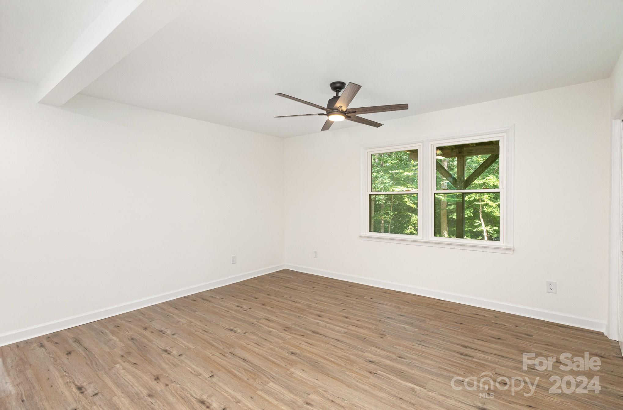 10625 East Lake Road Charlotte, NC 28215 - Photo 29 of 44 wooden floor in an empty room with a window