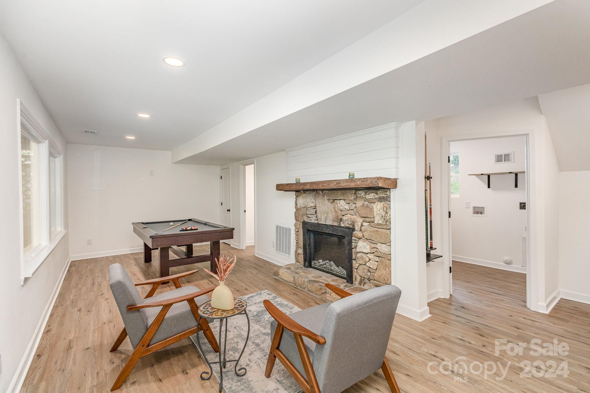 10625 East Lake Road Charlotte, NC 28215 - Photo 33 of 44 a living room with a fireplace and a table