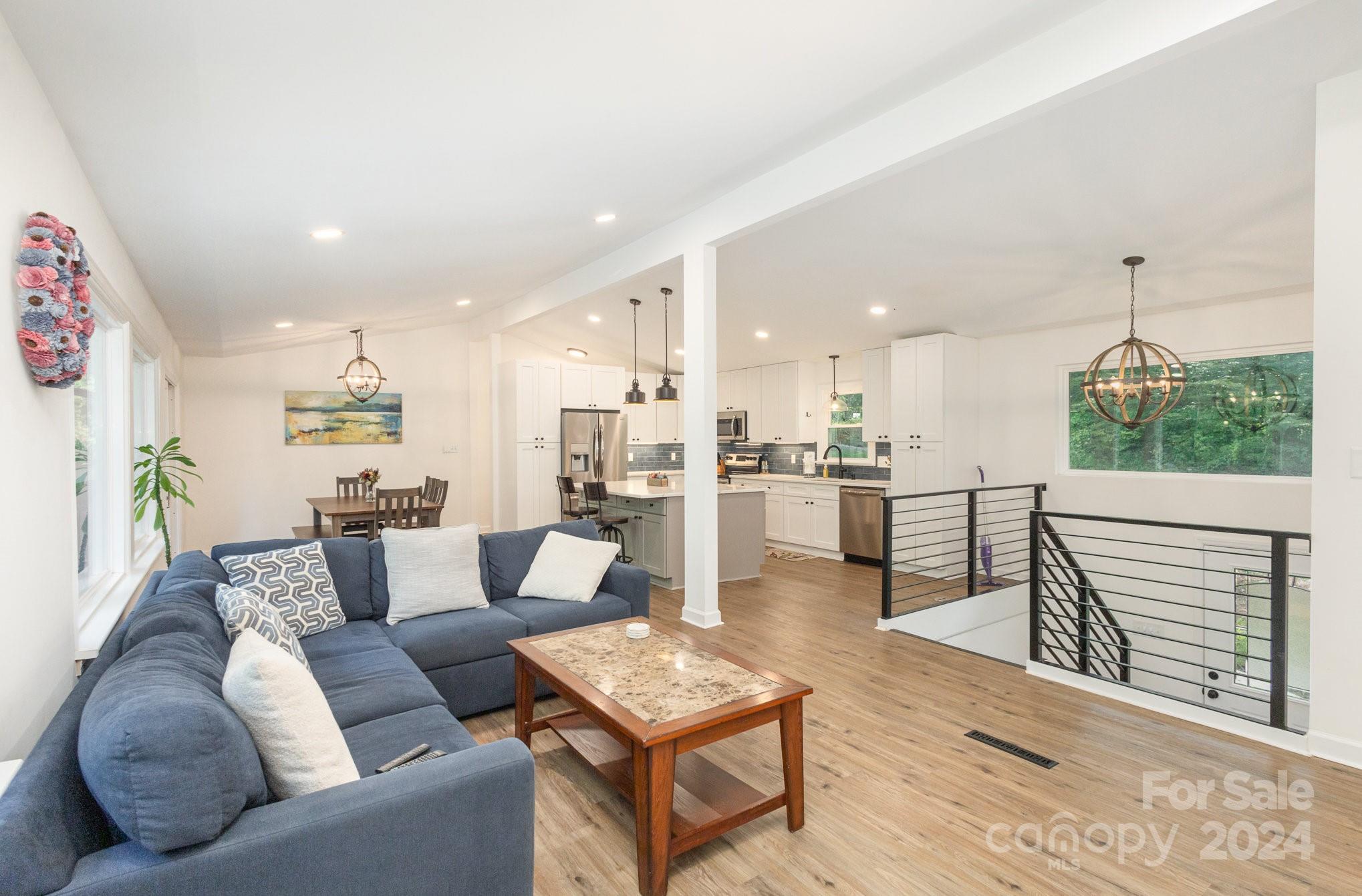 10625 East Lake Road Charlotte, NC 28215 - Photo 5 of 44 a living room with furniture and a table