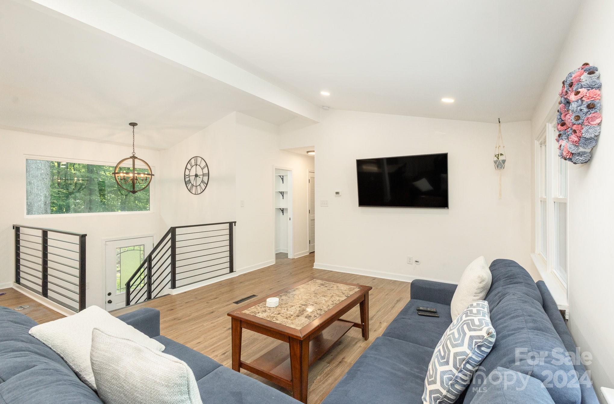 10625 East Lake Road Charlotte, NC 28215 - Photo 6 of 44 a living room with furniture and a flat screen tv