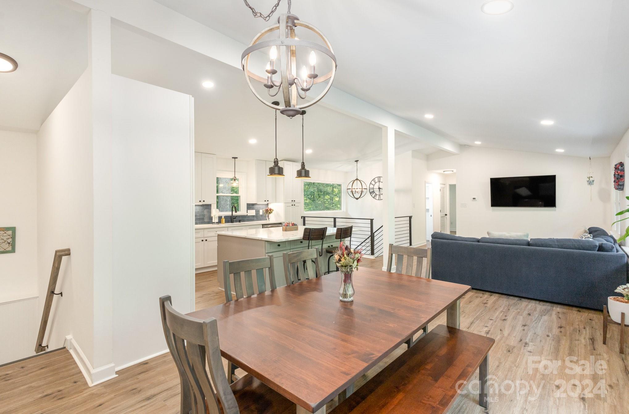 10625 East Lake Road Charlotte, NC 28215 - Photo 8 of 44 a view of a dining room with furniture wooden floor and chandelier