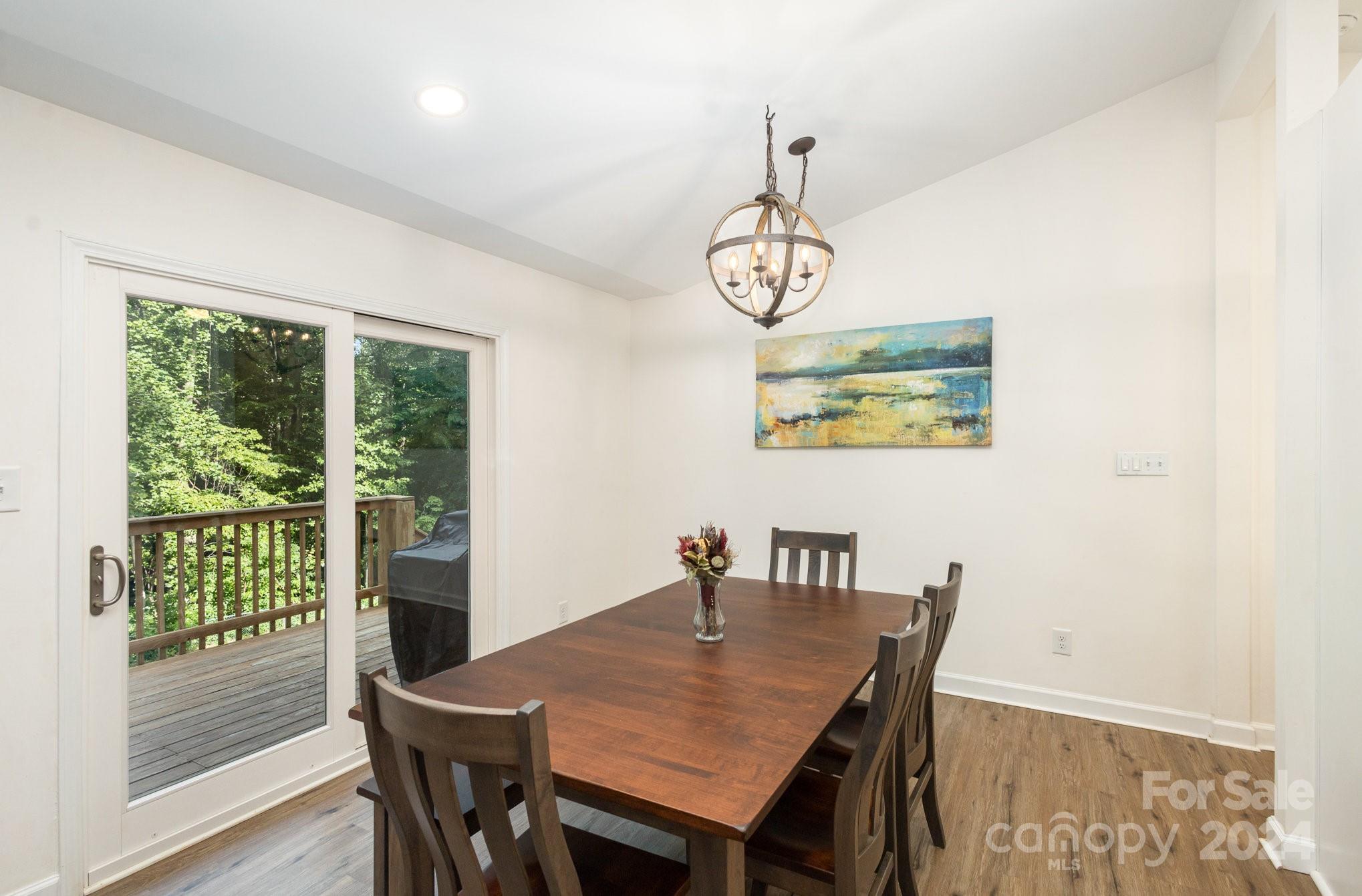 10625 East Lake Road Charlotte, NC 28215 - Photo 9 of 44 a view of a dining room with furniture window and wooden floor