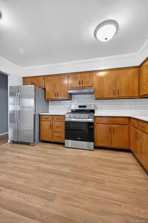 a kitchen with stainless steel appliances a stove a sink and a refrigerator