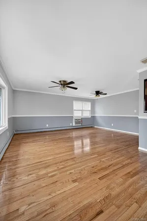 a view of a room with wooden floor
