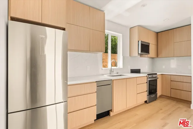 a kitchen with white cabinets and white appliances