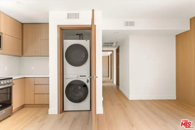 a view of a hallway with washer and dryer