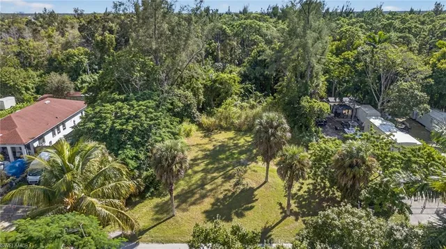 an aerial view of residential houses with outdoor space and swimming pool