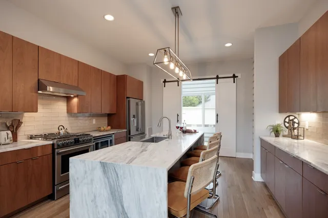 a kitchen with sink stove and cabinets